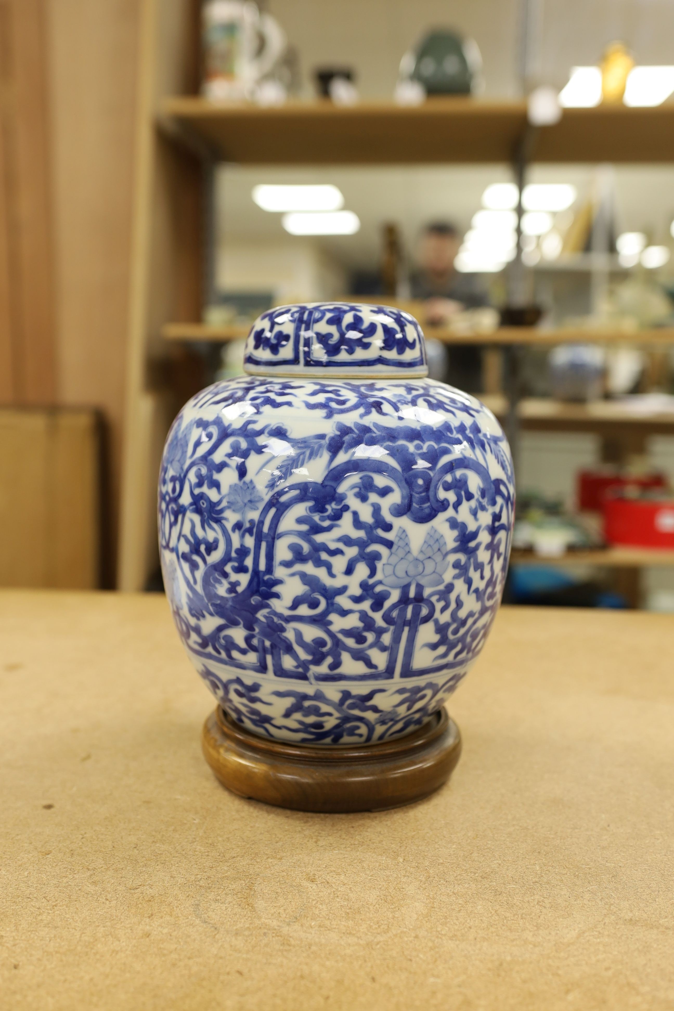 A pair of Chinese blue and white ginger jars and covers, 22cm, On stands